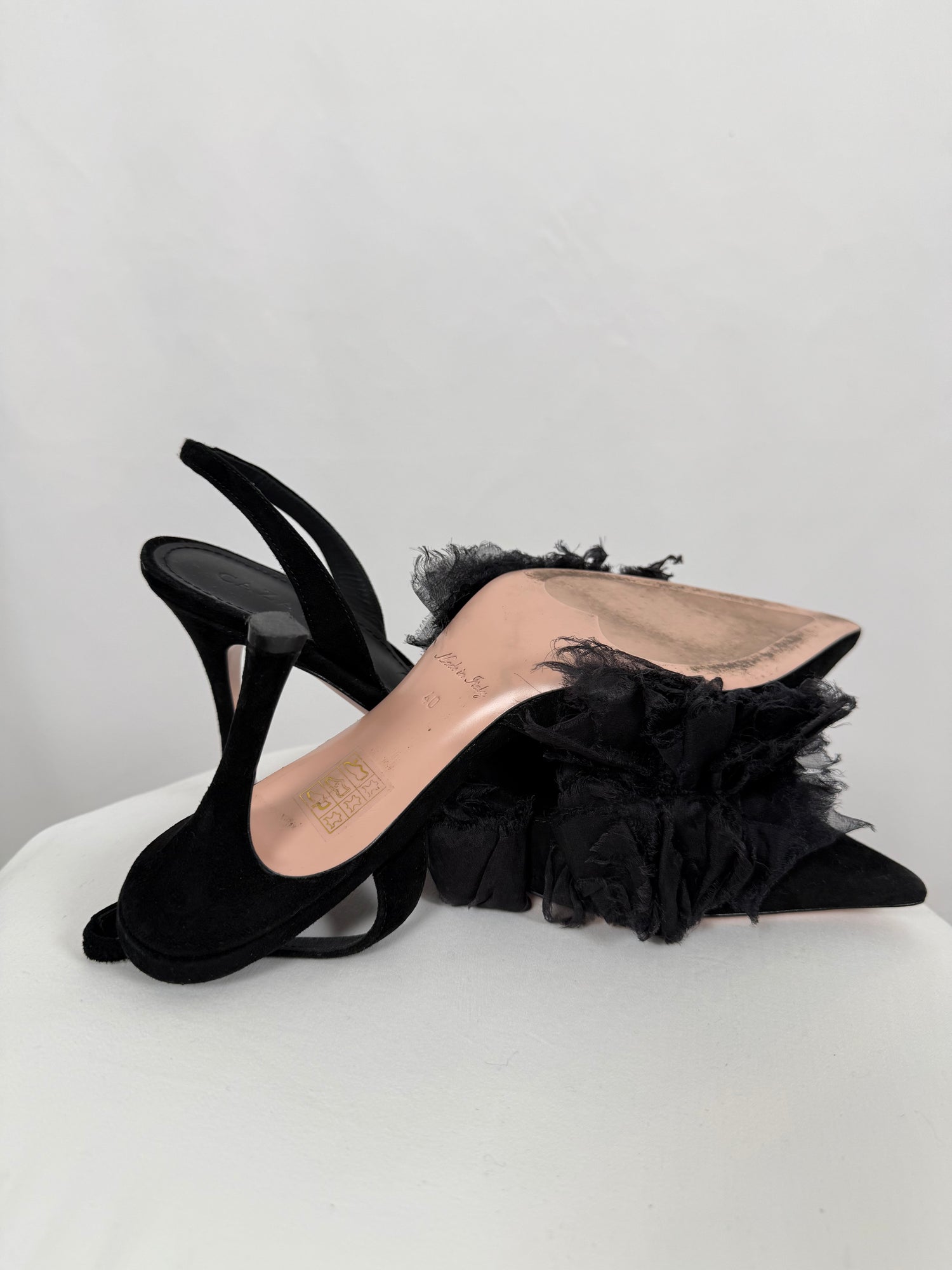 Black ruffled pumps