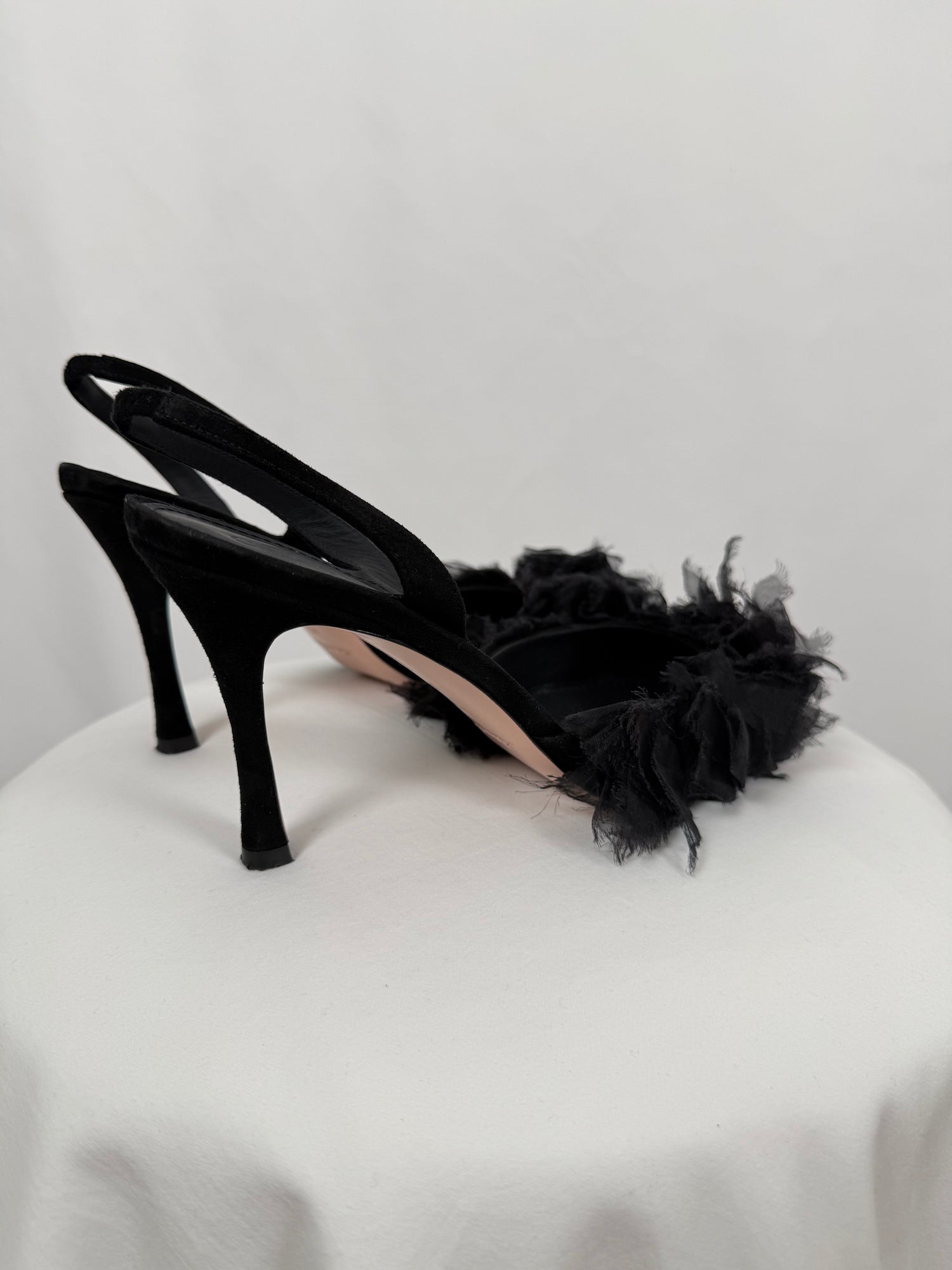Black ruffled pumps