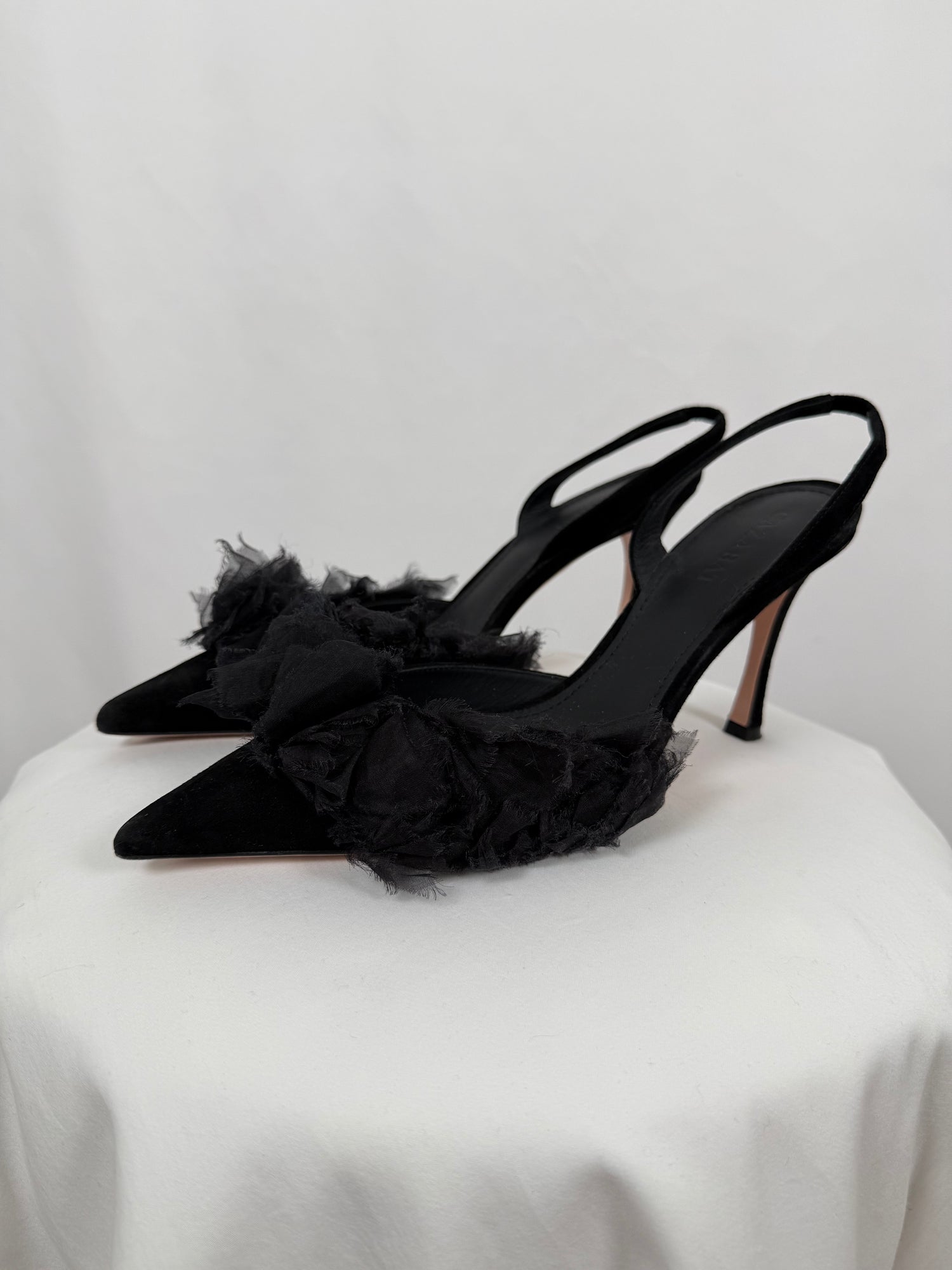 Black ruffled pumps