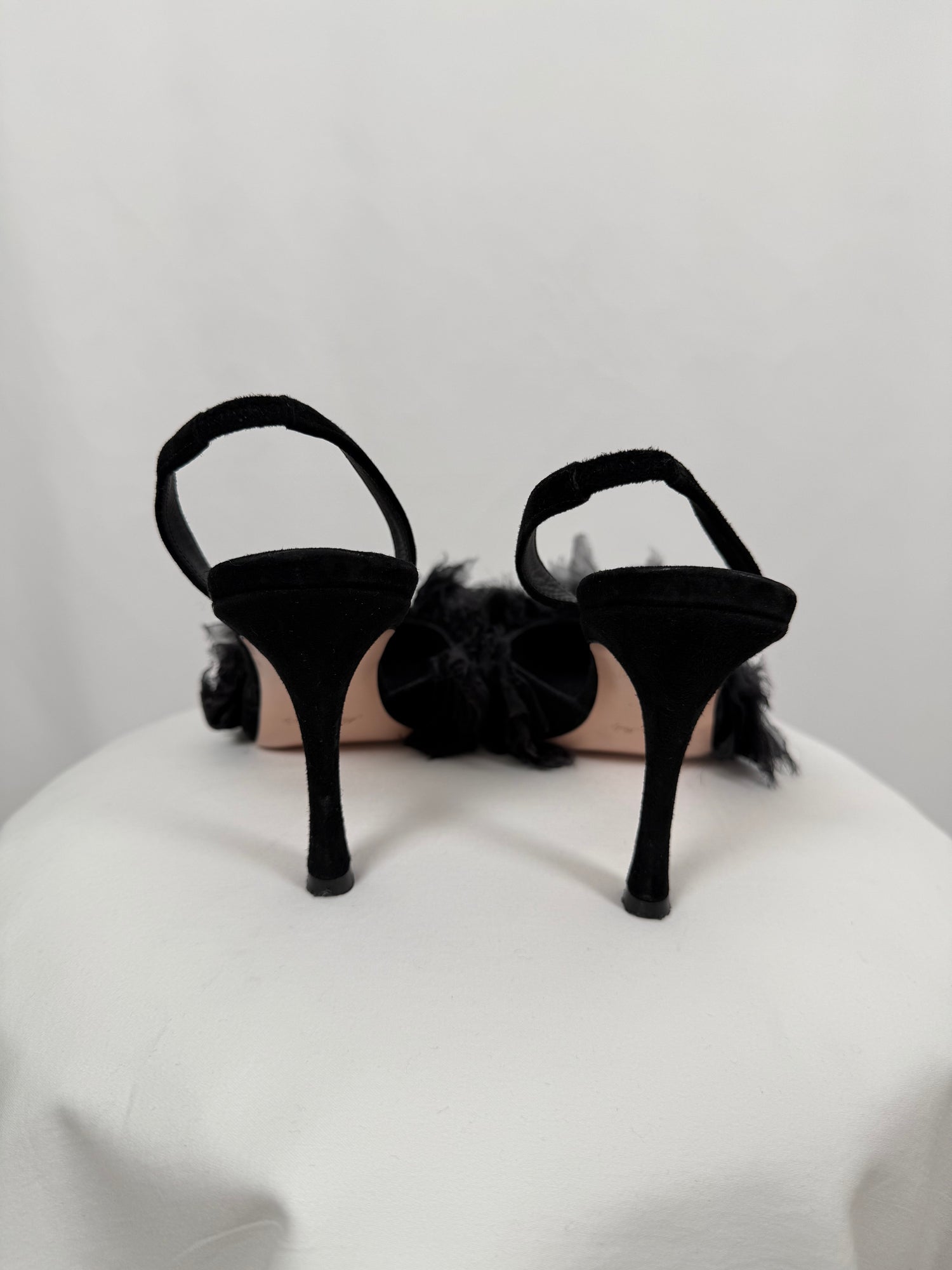 Black ruffled pumps